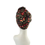 Patterned headscarf on a mannequin head against a white background
