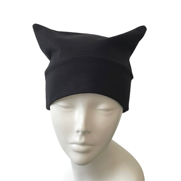 Black cat ears headband on a mannequin head against a white background