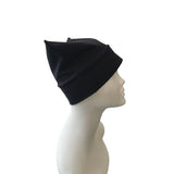 Black beanie on a mannequin head against a white background