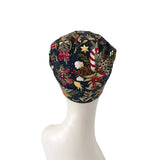 Decorative scrub cap with Christmas pattern on a mannequin head against a white background