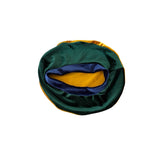 Green and gold fabric with a blue interior on a white background