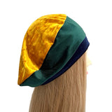Color-blocked headband with gold, green, and navy on a mannequin head against a white background ireland
