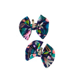 Two floral-patterned  bows with clips on a white background