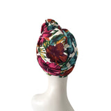 Colorful floral headscarf on a mannequin head against a white background