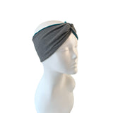 Gray headband with teal accent on a mannequin head against a white background