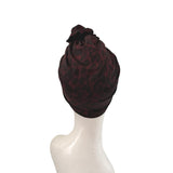 Dark red patterned headscarf on a mannequin head against a white background