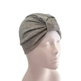 Gray headscarf on a mannequin head against a white background