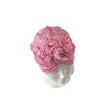 Pink patterned headscarf on a mannequin head against a white background