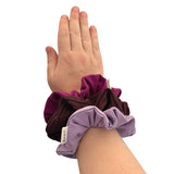 Hand wearing three scrunchies on a white background ireland