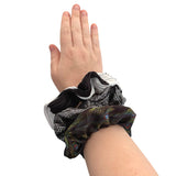Hand wearing a patterned scrunchie on a white background ireland