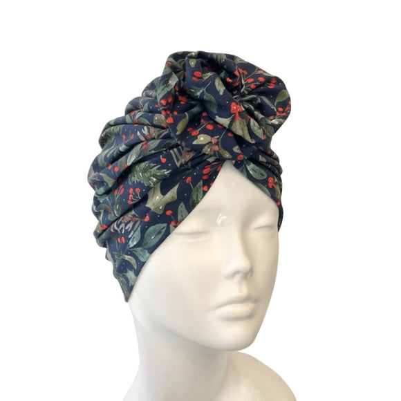 xmas patterned headscarf on a mannequin head against a white background