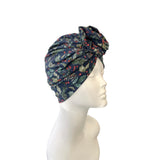 christmas patterned headscarf on a mannequin head against a white background