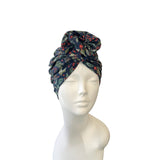 holly patterned headscarf on a mannequin head against a white background