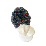 firtree patterned headscarf on a mannequin head against a white background