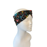 Floral patterned headband on a mannequin head against a white background