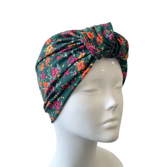 Floral patterned headscarf on a mannequin head against a white background