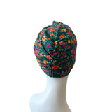Floral-patterned headscarf on a mannequin head against a white background