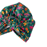 Floral headscarf with colorful flowers on a green background