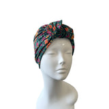 Floral patterned headscarf on a mannequin head against a white background