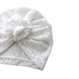 White lace headband with a bow on a white background
