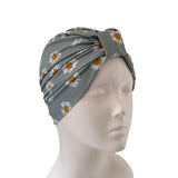 Gray headscarf with floral pattern on a mannequin head against a white background