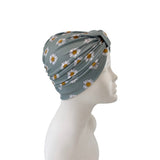 Gray headscarf with floral pattern on a mannequin head against a white background