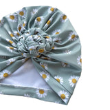 Turban with daisy pattern on a white background