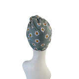 Floral headscarf on a mannequin head against a white background
