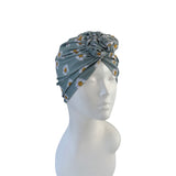Floral patterned headscarf on a mannequin head against a white background
