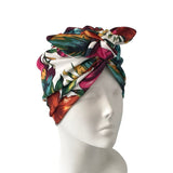 Colorful headscarf with butterfly design on a mannequin head against a white background
