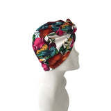 Colorful floral headscarf on a mannequin head against a white background
