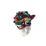 Colorful head wrap on a mannequin head against a white background