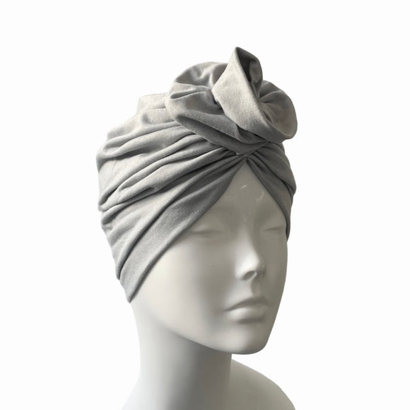 Gray headscarf on a mannequin head against a white background