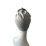 Gray headscarf on a mannequin head against a white background
