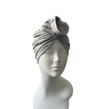 Gray headscarf on a mannequin head against a white background