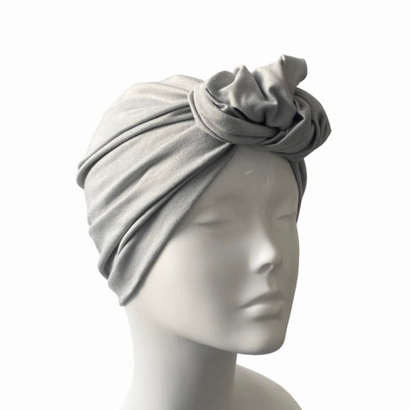 Gray headscarf on a mannequin head against a white background