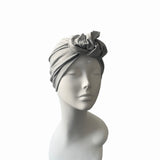 Gray headscarf on a mannequin head against a white background