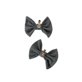 Two gray bow-shaped accessories on a white background