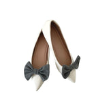 White shoes with gray bow decorations on a white background