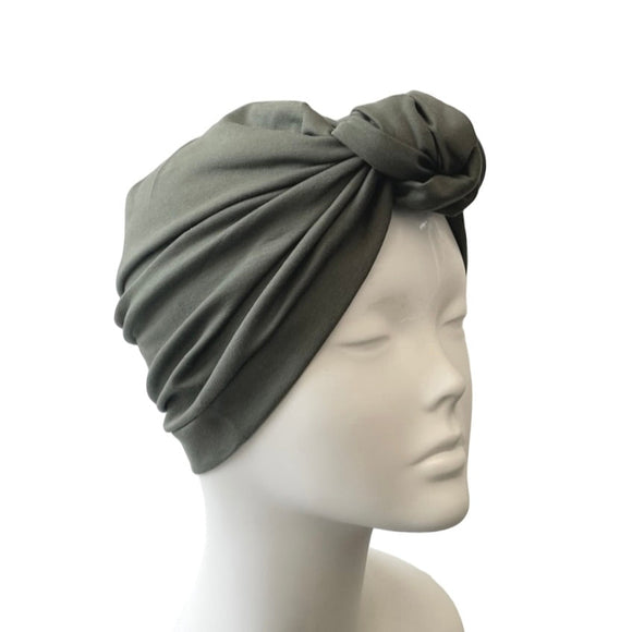 Gray headscarf on a mannequin head against a white background