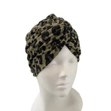 Leopard print turban on a mannequin head against a white background