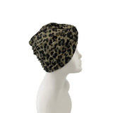 Leopard print headscarf on a mannequin head against a white background