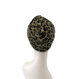 Leopard print headscarf on a mannequin head against a white background