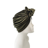 Green headscarf with a knot on a mannequin head against a white background