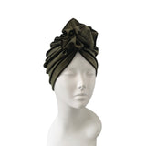 Green headscarf on a mannequin head against a white background