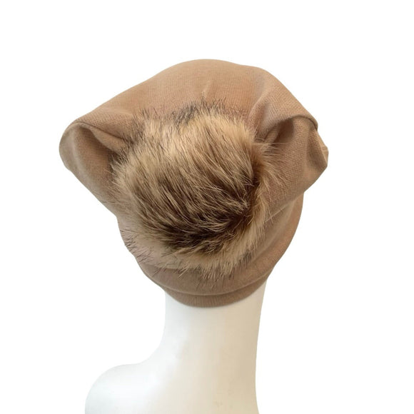 Brown fur hat on a mannequin head against a white background