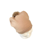 Beige beanie with fur pom-pom on a mannequin head against a white background