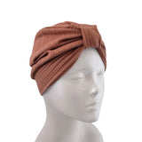 A textured, ribbed brown headwrap turban hat displayed on a white mannequin head against a solid white background.