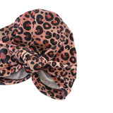 Leopard print headscarf with a knot on a white background