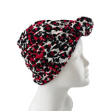 Leopard print headscarf on a mannequin head against a white background